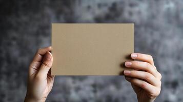 Woman holding a blank piece of paper in her hands photo