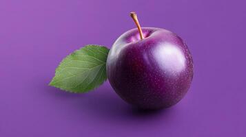 A purple apple with a leaf on it photo