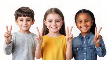 Three children making peace signs with their hands photo