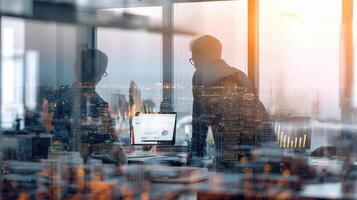 Two people working in an office with a view of the city photo