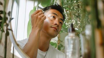A man is putting on his makeup in front of a mirror photo