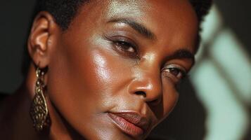 A woman with dark skin and earrings photo