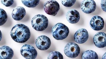 Blueberries are arranged in a pattern on a white surface photo
