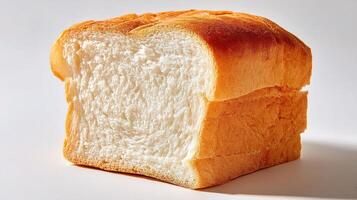 A piece of bread is shown on a white surface photo
