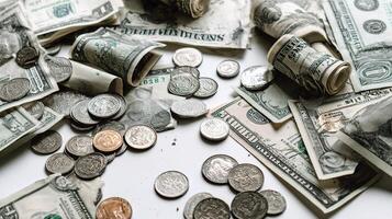 A pile of money and coins on a white surface photo