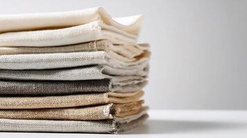 A stack of folded linen on a white table photo