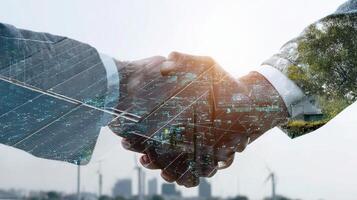 Two business people shaking hands in front of a solar panel photo