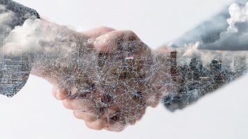 Business people shaking hands with cityscape in background photo