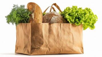 A brown paper bag filled with bread, vegetables and herbs photo