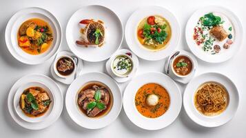 A variety of dishes are arranged on white plates photo