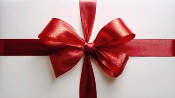 A red ribbon tied around a gift box photo