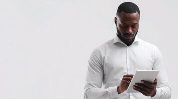 A man in a white shirt is using a tablet photo