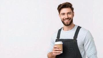 A man in overalls holding a coffee cup photo
