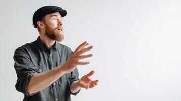 A man with a beard and hat is gesturing photo