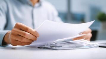 A person is holding a piece of paper and a piece of paper photo