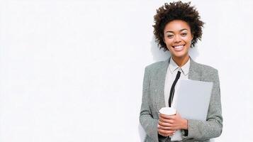 A woman in a business suit holding a folder and cup photo