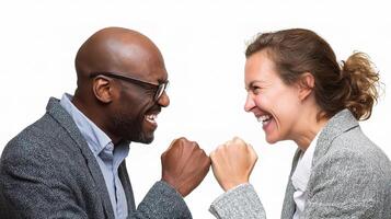 Two people in business attire are fist bumping photo
