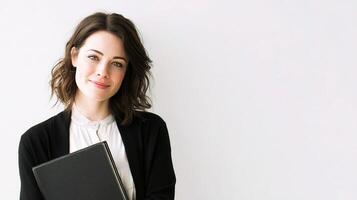 A woman holding a laptop in front of her photo