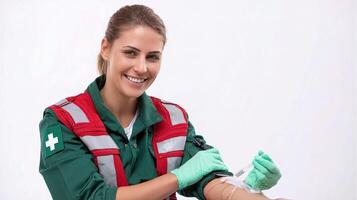 A woman in a red and green uniform is holding a blood pressure cuff photo