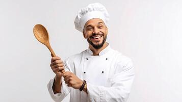 A smiling man in a chef hat holding a wooden spoon photo