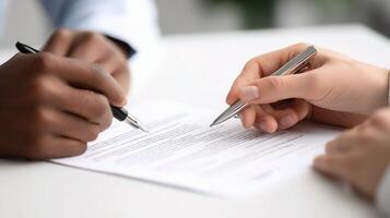 Two people signing a contract on a desk photo