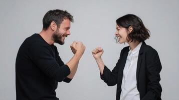 A man and woman are fighting against each other photo