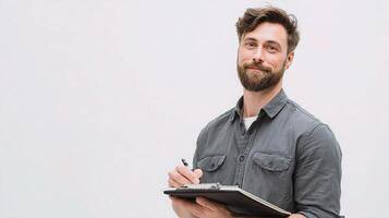 A man with a beard holding a clipboard photo