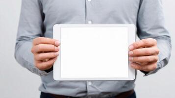 A man holding up a tablet with a blank screen photo