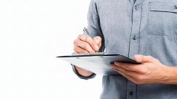A man holding a clipboard and writing on it photo
