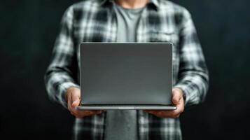 A man holding a laptop computer in his hands photo