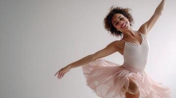 A woman in a pink tutu skirt is dancing photo