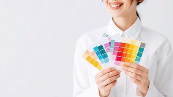 A woman holding up a color swatch card photo