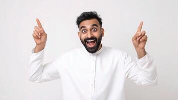 Portrait of a happy arab man with a surprised expression on his face, pointing his fingers photo