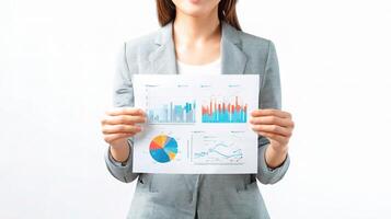 A woman in a business suit holding a paper with graphs and charts photo