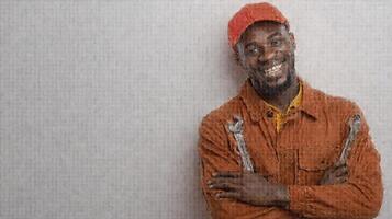 Smiling African Maintenance Worker Holding Wrenches in Uniform photo
