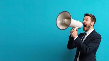 A man in a suit is shouting into a megaphone photo