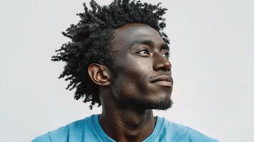 A man with dreadlocks looking up photo