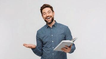 A man is holding a book and smiling photo