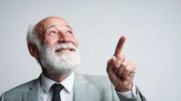An older man with a white beard pointing up photo