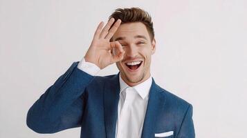 A man in a suit is making an ok sign photo