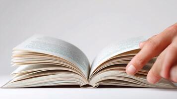 A person is pointing at an open book photo