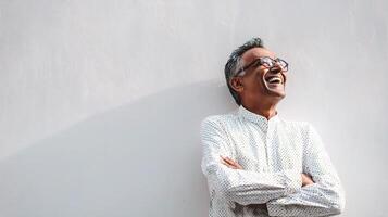 A man with glasses and a white shirt is smiling photo