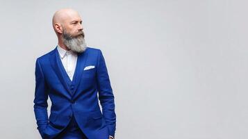A bald man in a blue suit with a beard photo