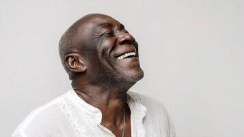 A smiling black man with white shirt photo