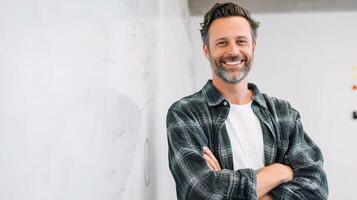 A man with a beard and plaid shirt standing in front of a whiteboard photo