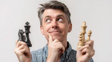 A man holding two chess pieces in front of his face photo