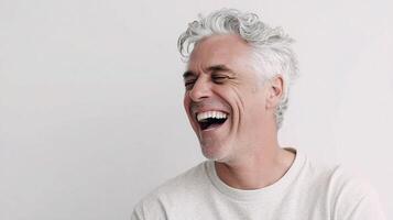 A man with white hair is laughing photo