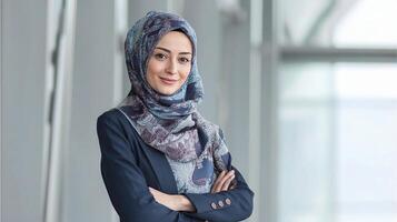 A woman wearing a hijab standing in an office photo