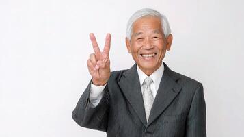 An older man in a suit and tie making the peace sign photo