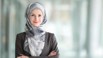 A woman wearing a hijab standing in front of a building photo